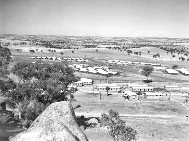Looking west showing compounds of the Cowra prisoner of war camp with the group headquarters buildings in the foreground. AWM