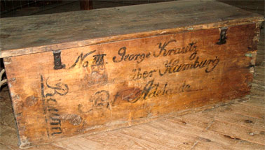 Timber cabin chest from collection with the inscription clearly visible on the side. Image courtesy of the Jindera Museum
