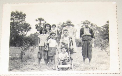 Lina is in the pram with her cousin, three siblings, mother, uncle and paternal grandmother in Battambang province, Cambodia, c. 1961