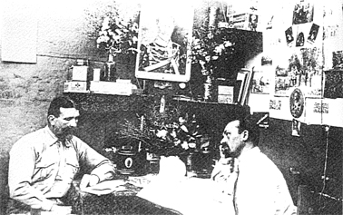 <em>Walter Bergien and Otto Mönkedieck (right) in their cell. Mönkedieck is working on his playbill for the internee's play </em>Im Bunten Rock<em>, c. 1917. <br>Berrima Museum Collection (From Simons)</em>