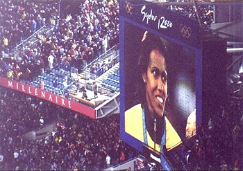 Cathy Freeman on large screen, Olympic Stadium, 2000. Courtesy SLNSW