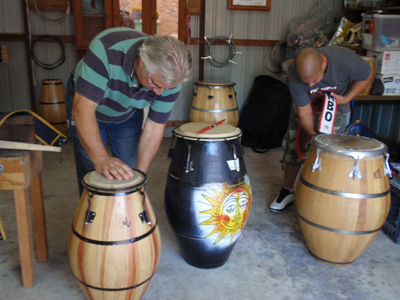 Workshop of Candombe Yauguru drum maker - Raul Pamies - Raul and Juan-Carlos Quijano (Director, Candombe Yauguru) attaching shoulder straps to drums 