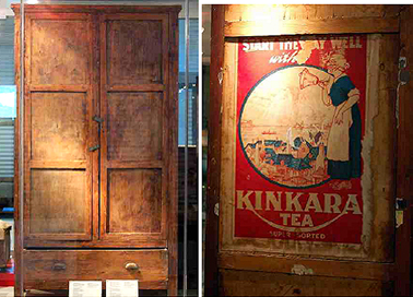 Cupboard showing detail of tea chest label on inside of the door.