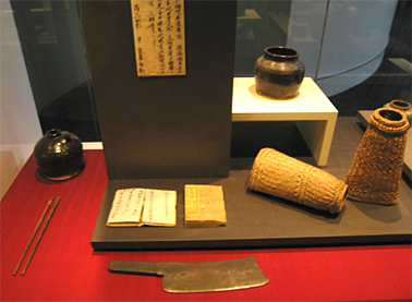 From left: Soy sauce jar, chopsticks, Book (New Testament) meat clever, wide mouth jar, wrist protectors, c1850-80s. Wong Collection. Photograph Stephen Thompson