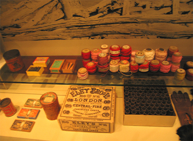 From left: Front: Tin of baking soda c.1890s, violin strings c.1880s, tin of ham cured herrings c.1880s, shotgun cartridge cases and packaging c.1900s, gloves c.1890- 1910. Rear: tin of Coachaline leather dressing c.1890s, ink pen nibs c.1900, tweezers c.1900, cotton threads c.1900. Wong Collection. Photograph Stephen Thompson