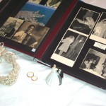 "Our wedding photo album, two gold wedding bands and small figurines of the bride and groom."