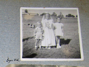Anne Birdsey with siblings at Scheyville in her First Holy Communion dress