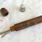 "I did all the sewing and darning for my family in Holland. I used this needle container for my darning needles. The thimble belonged to my Tante Margje, my mother's sister, who died when I was about 4 years old. My mother gave it to me as a gift."