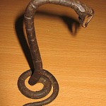 "The snake was made during WW2 from the melted remains of hand grenades and originally belonged to my mother. It's a decorative piece standing in a coiled position and stands about 20cms high."