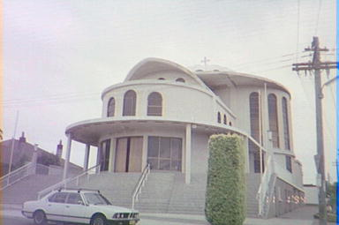 All Saints Greek Orthodox Church, 33 Isabel Street, Belmore, c.1994. In 1963, a group of parents established a Greek Orthodox Community at Belmore, including the establishment of a church. On 22 March 1964 the All Saints Anglican Church at Belmore was purchased with donations from the local Greek Orthodox Community. When the building became too small, two cottages opposite were purchased and demolished to provide a new site. The new church was officially opened on 10th June 1972