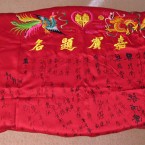 The Chinese marriage tradition in Hong Kong [is] reception guests sign the wedding tablecloth. China was still rather poor so most [there] couldn’t afford a reception. We buy that tablecloth for our wedding. Yellow and red are the celebration colour in Chinese. Yellow characters are the names of the bride and groom and our wedding date. Embroidered drawing signifies the dragon and phoenix - very good omen creatures. When we migrated here we think that is the thing we need to bring along.